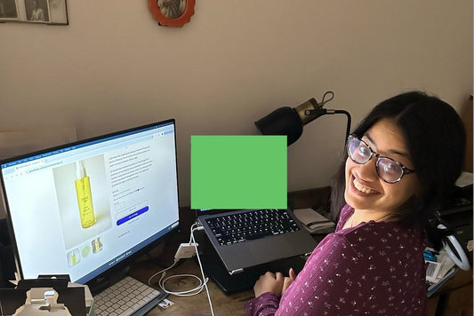 Mehgha the founder sitting with 2 computer screens showing the gramah baby website 