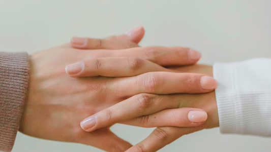 two hands interlocking with each other