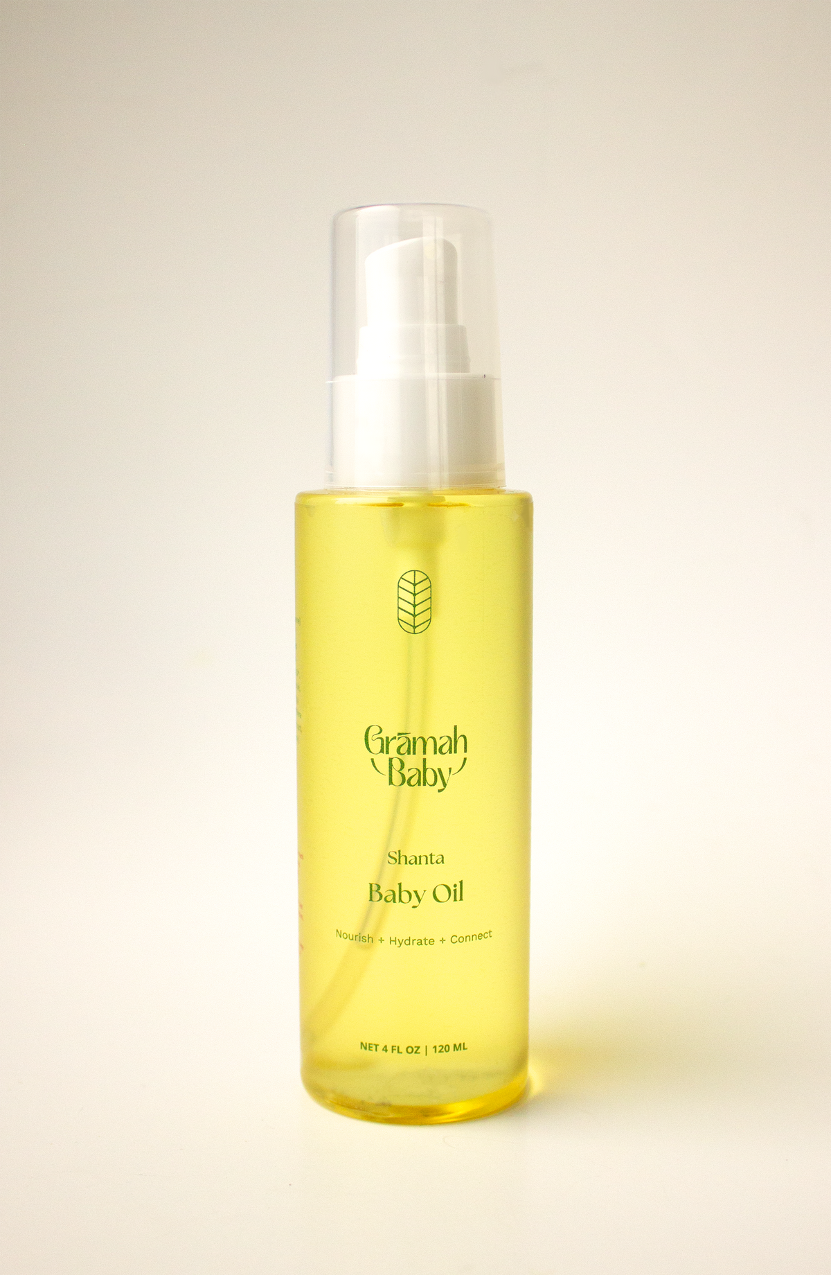 Shanta Baby Oil- yellow oil in a clear plastic bottle with a cap against a plain ivory background